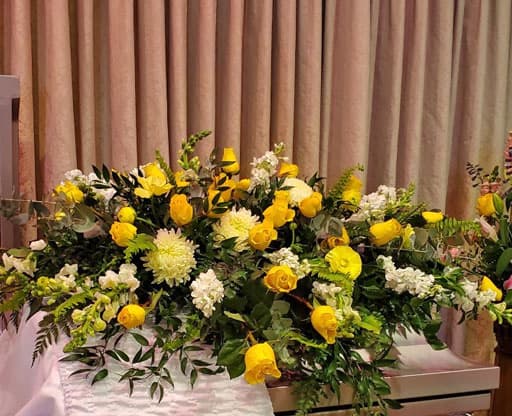 Yellow funeral floral arrangement