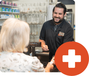 A Harmons pharmacist helping a customer at the pharmacy counter